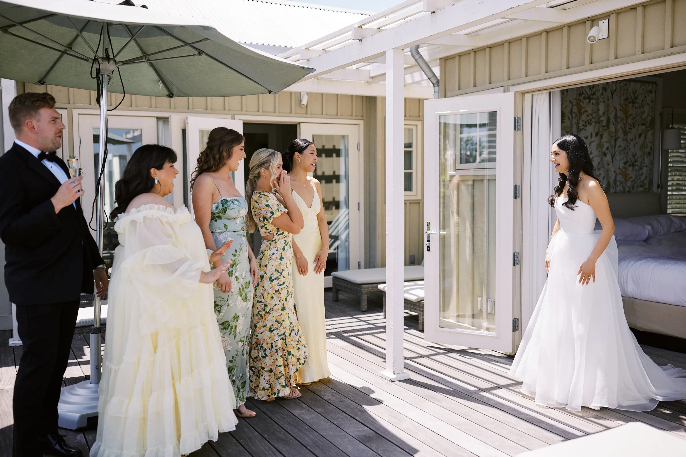 The bridal party seeing the bride in her dress for the first time