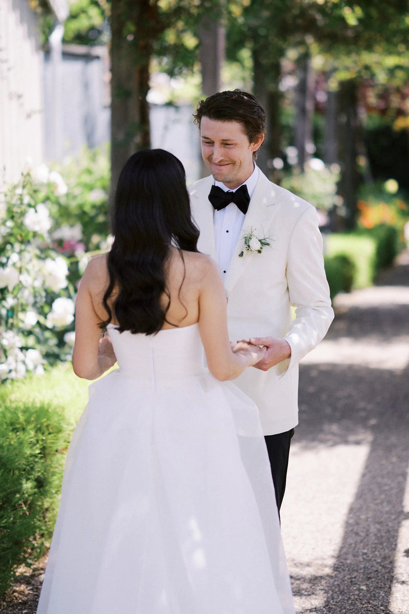 The couple's first look on a garden path